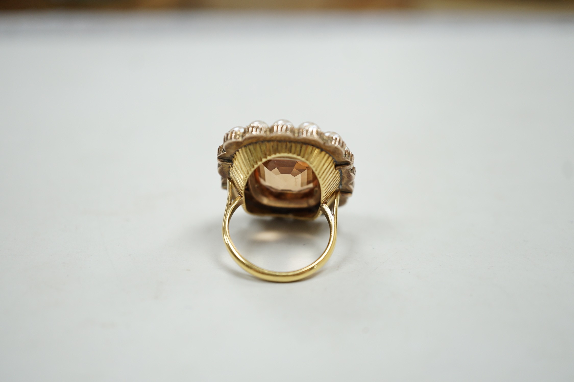 A mid 20th century gold, orange topaz and split pearl set cluster ring (adapted from an earlier brooch), size M/N, gross weight 15.7 grams.